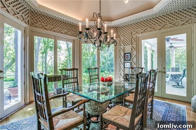 Bluffview's Private 2-Acre Urban Sanctuary 17 Charming breakfast area with intricate millwork, serene tree views, and French doors to a covered patio