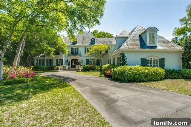 Bluffview's Private 2-Acre Urban Sanctuary 3 Grand curb appeal of a French-style Dallas luxury home with mature trees and pristine landscaping