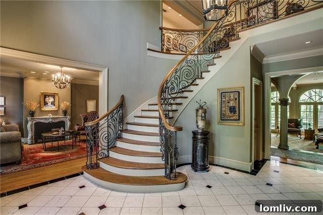 Bluffview's Private 2-Acre Urban Sanctuary 10 Dramatic double-height entryway featuring a gracefully curving staircase with custom wrought iron balustrades