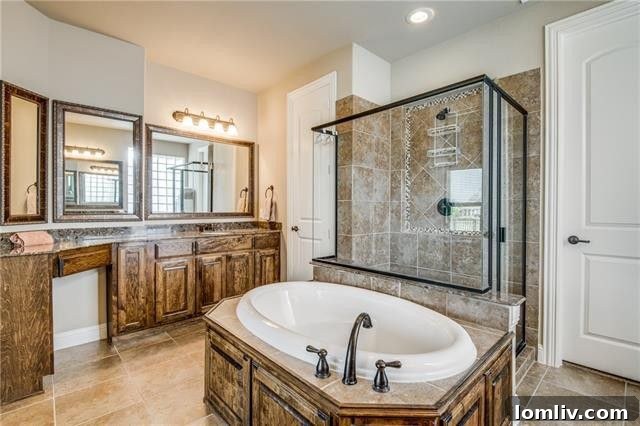 Elegant master bathroom featuring a spacious walk-in shower and a deep soaking tub.
