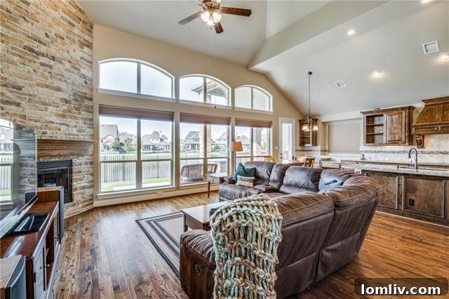Cozy great room featuring a stunning floor-to-ceiling stone fireplace, ideal for relaxation and gatherings.