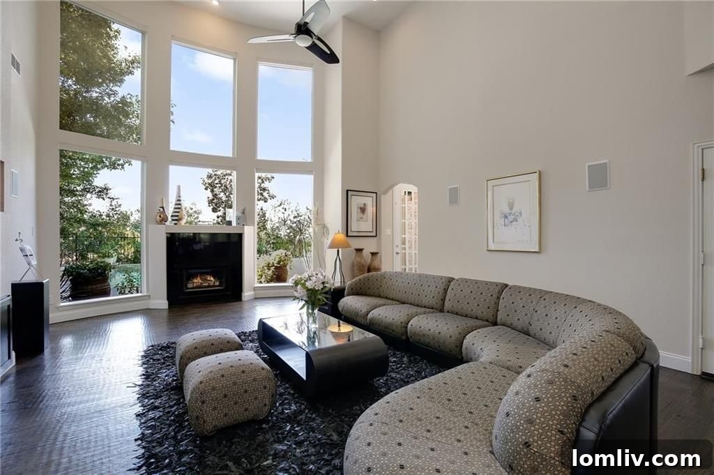 Two-Story Living Room with Pool View and Electric Fireplace