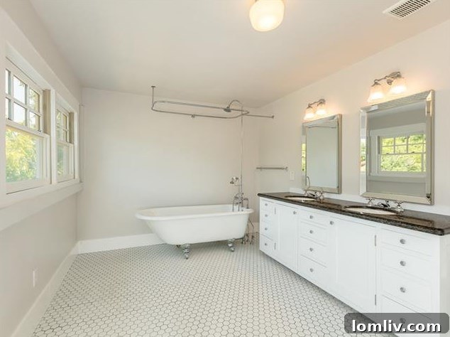 Hemphill Heights Classic: Craftsman Home with Untapped Potential on Travis Avenue 12 Master bathroom with a classic clawfoot tub and modern double sink vanity, combining vintage and contemporary styles