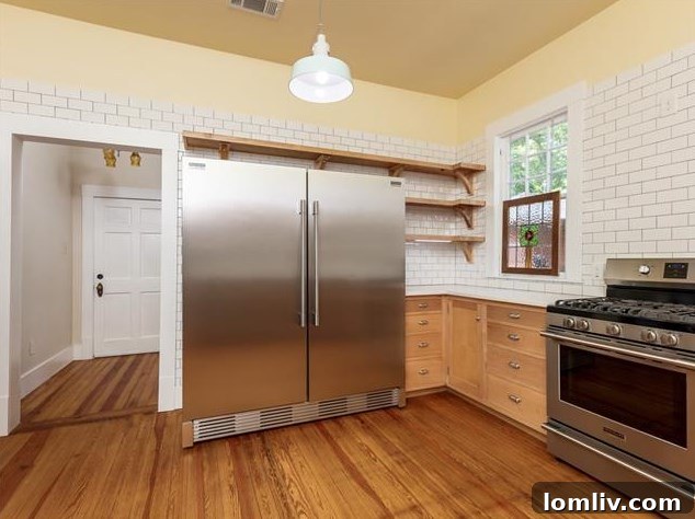 Hemphill Heights Classic: Craftsman Home with Untapped Potential on Travis Avenue 8 Spacious kitchen with white subway tile, high-end stainless steel appliances, and professional design
