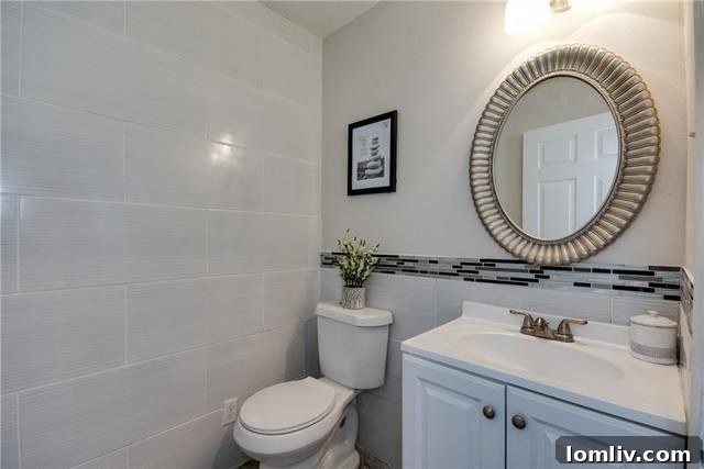 One of the tastefully updated bathrooms featuring designer tiles and modern fixtures.