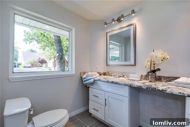 Detail of the bathroom's chic hardware and contemporary vanity.