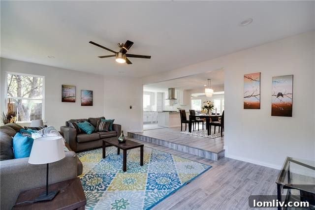 Another perspective of a sun-drenched living area, showcasing recessed lighting and large windows.