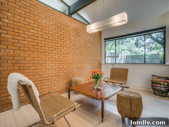 Dining area with modern light fixture and artwork