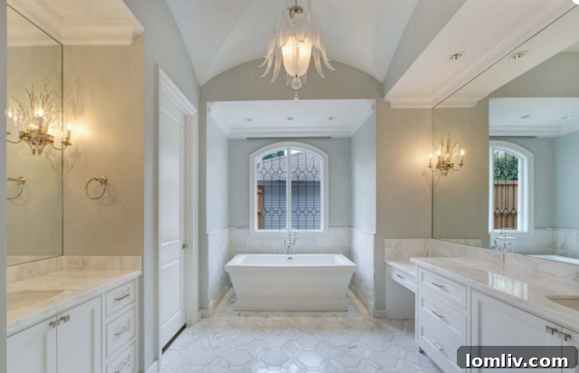 Luxurious bathroom with modern fixtures and elegant tiling by HGC