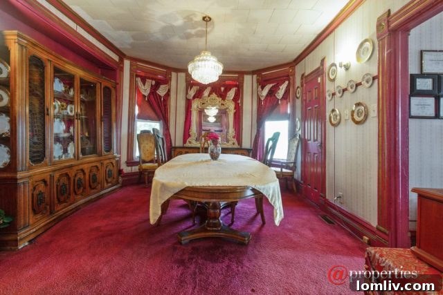 Another perspective of a pink themed room, showcasing textiles, furniture, and wall decorations