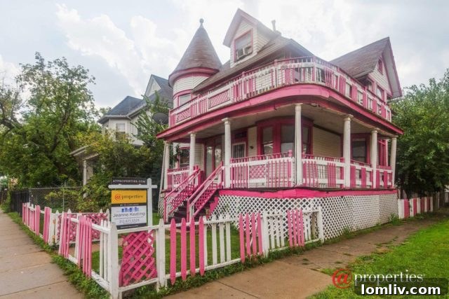Side view of the pink house with intricate architectural details and windows
