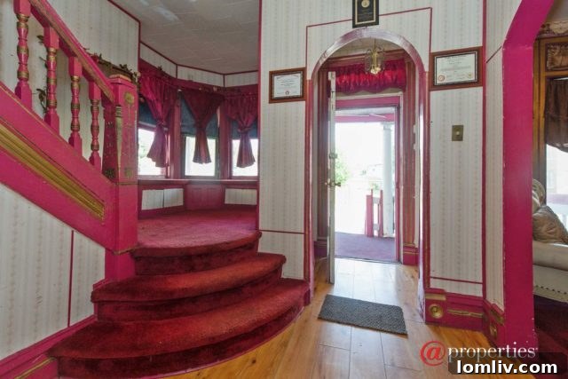 Grand entrance hallway of the pink Chicago home, adorned with ornate decor