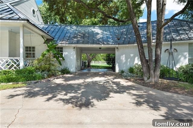 Rear exterior view of the modern farmhouse with extensive landscaping
