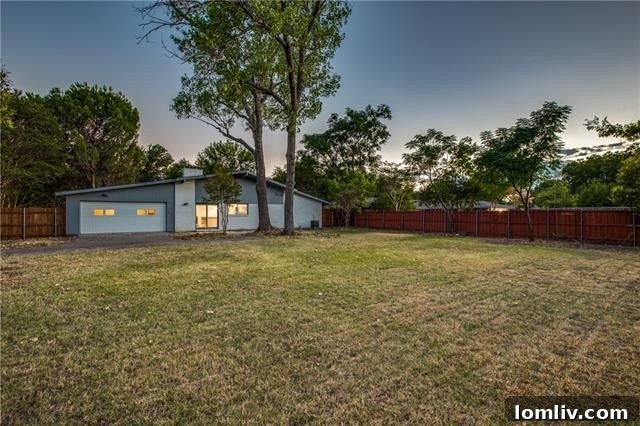 Expansive backyard of the home, showing a large grassy area, perfect for family activities and potential for a pool.
