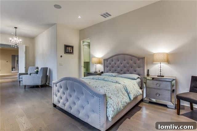 The impressive master bathroom with dual marble vanities, separate tub, and shower.