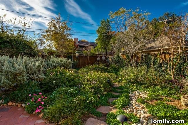 Updated kitchen with white custom cabinets, granite countertops, and modern appliances.