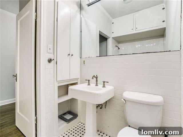 Vanity area in an updated bathroom with stylish hardware