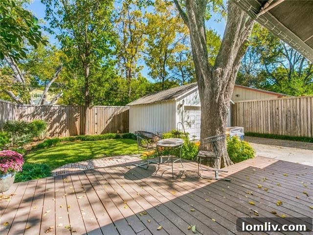 Large outdoor deck surrounded by lush landscaping