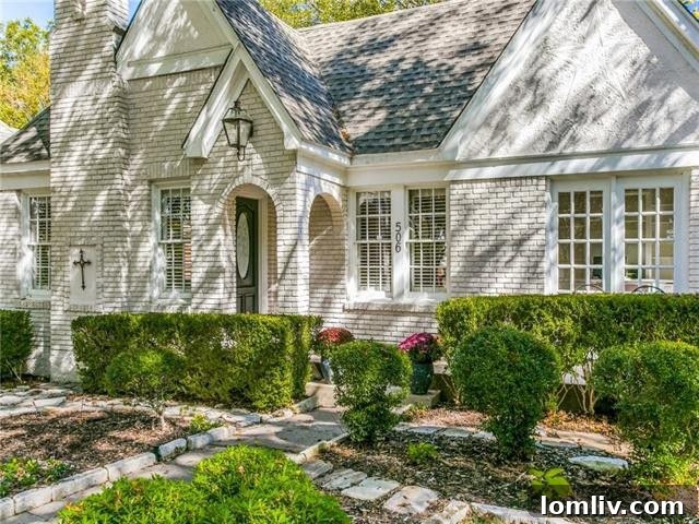 Lush front yard and mature trees of a Hollywood Heights Tudor