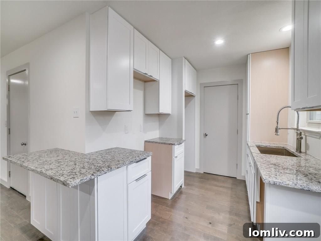 Modern kitchen with white cabinets and granite countertops