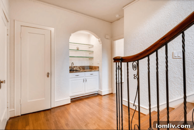 Ruth Story Wins Exclusive Windsor Place Listing 12 Staircase landing with a built-in wet bar and elegant railing details