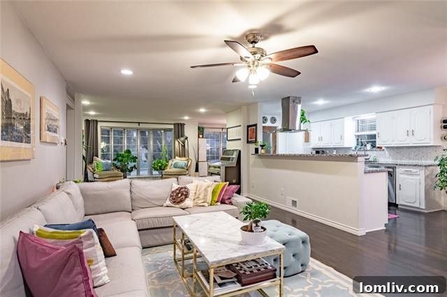 Inviting living room with contemporary light fixtures and ample seating.