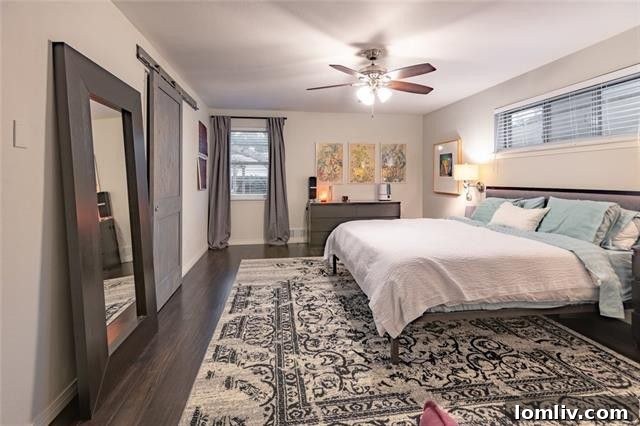 Another view of the living space highlighting the laminate wood flooring.