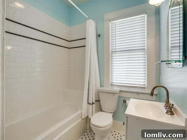 Sparkling clean, renovated bathroom with contemporary tiling and fixtures.