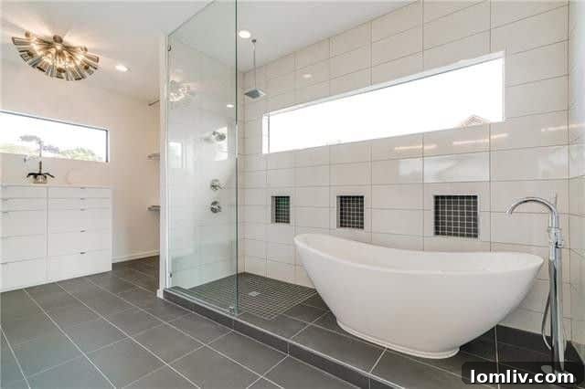 Elegant master bathroom with freestanding tub and glass shower