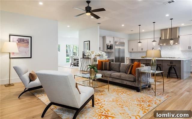 Open concept living room with fireplace and view of kitchen