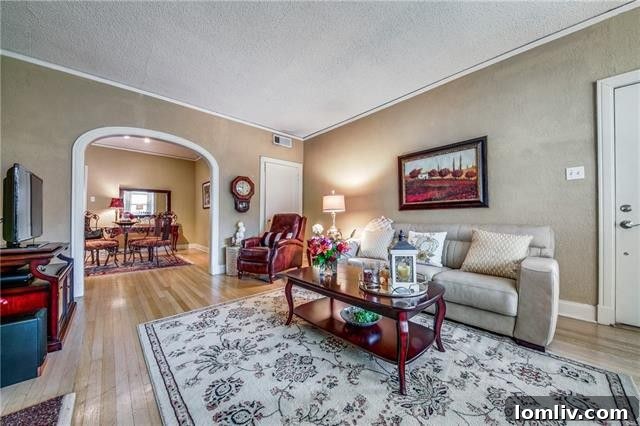 Spacious living area of a duplex unit with ample natural light