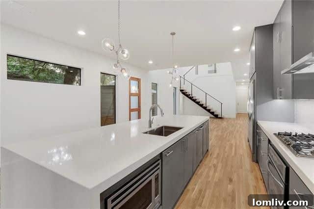 Spacious open-concept living area with tall ceilings and white oak floors