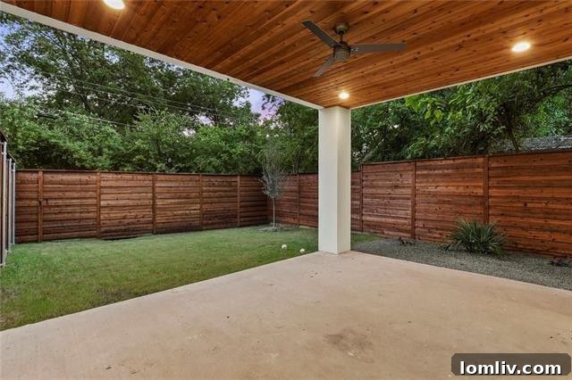 Spacious living room opening to outdoor patio through sliding glass doors