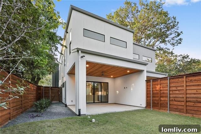 Covered outdoor patio with stained pine ceiling and private yard access
