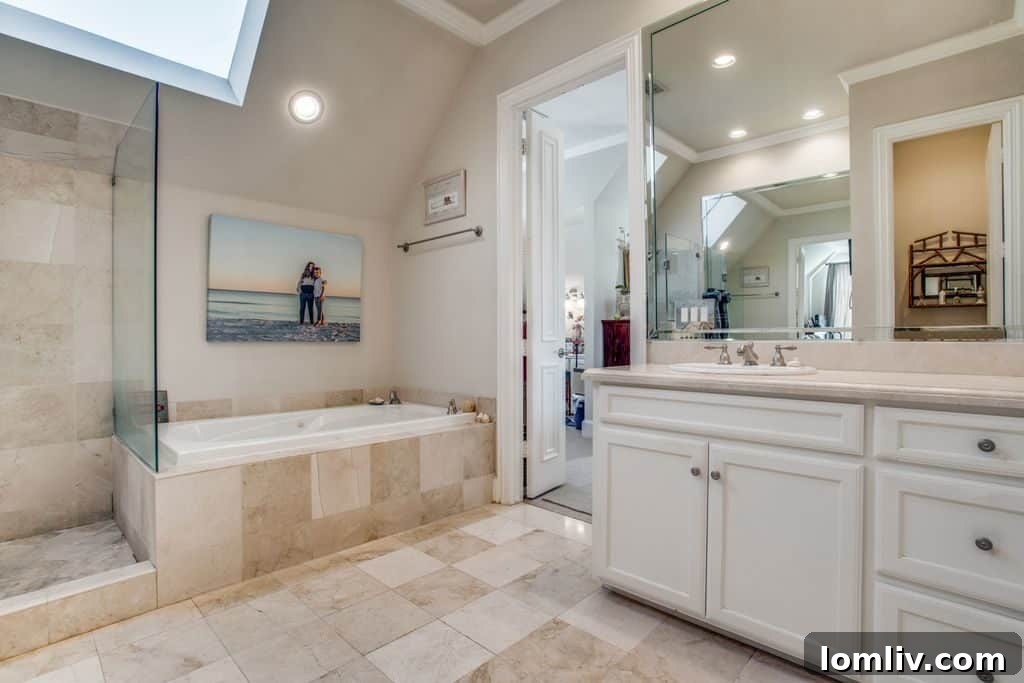 Master bathroom with dual vanities and a spacious glass shower