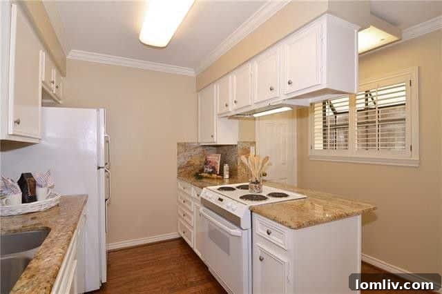Galley kitchen with white appliances and a breakfast nook