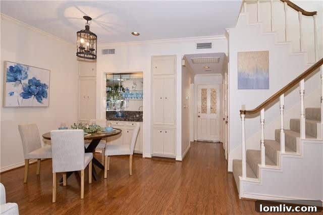 Dining area with a wet bar and marble countertop