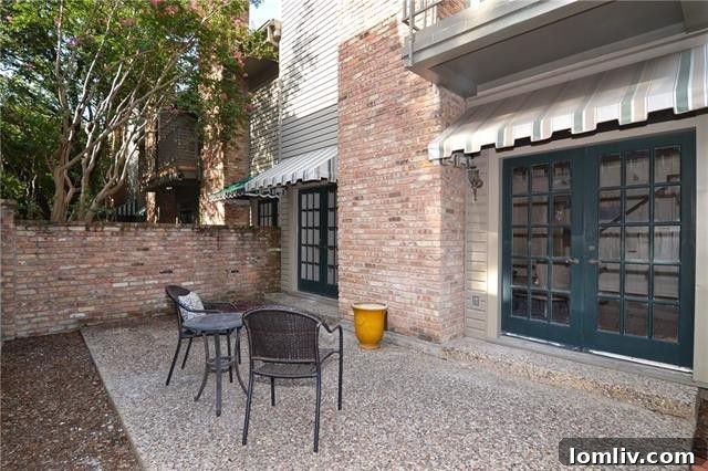 Private patio with outdoor seating surrounded by greenery