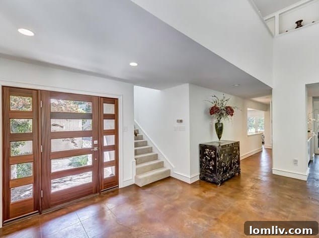 Open-concept living room with high ceilings and gallery