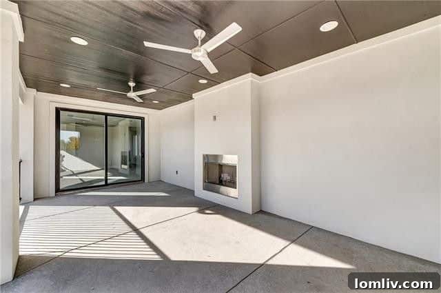 Upstairs balcony with an outdoor fireplace, perfect for year-round entertaining at 157 Magnolia Lane
