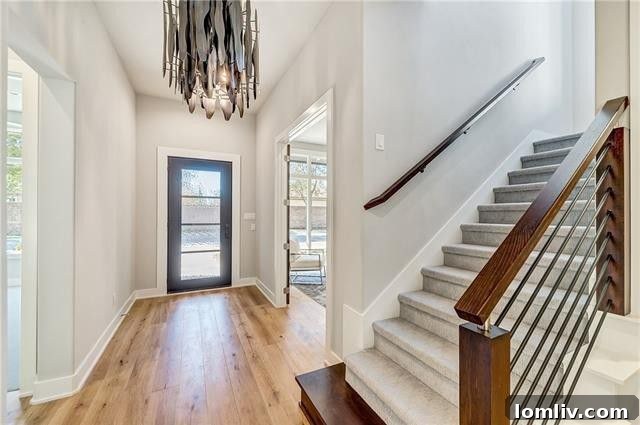 Intricate wrought iron staircase railings and luxurious interior finishes in a Fort Worth custom home