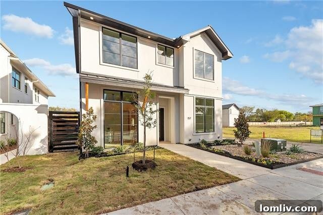 Spacious open-concept living area with large windows, natural light, and white oak floors in 157 Magnolia Lane
