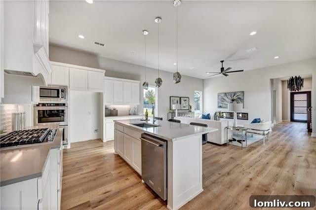 Gourmet kitchen with stainless steel appliances, quartz countertops, and a large island in a Fort Worth luxury home