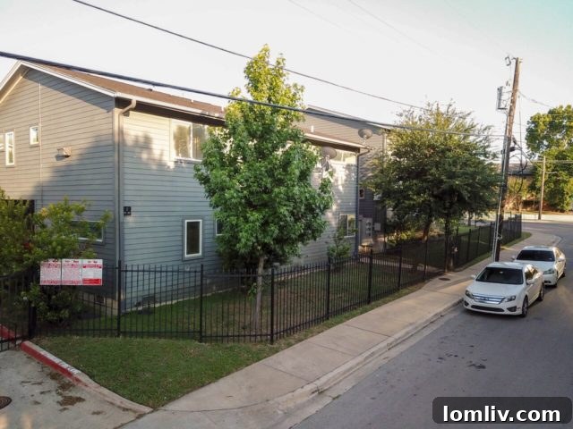 Modern kitchen with stainless steel appliances and granite countertops in a Saragosa Condo.
