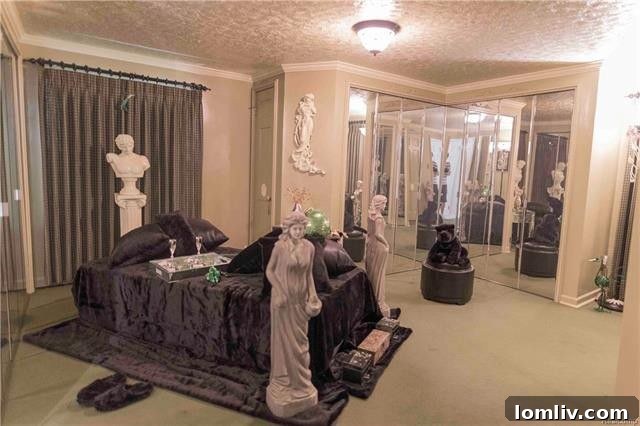 A bedroom within the Lion Gate Estate, featuring numerous statues as part of its unique decor