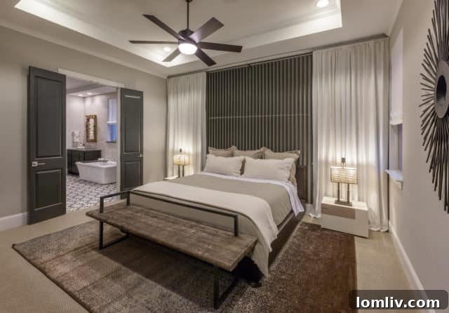 Contemporary kitchen with dark lower cabinets and light upper cabinets, featuring a large island