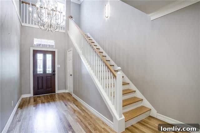 Elegant living area on the first floor of an Uptown Dallas townhome, featuring wood floors and modern lighting.
