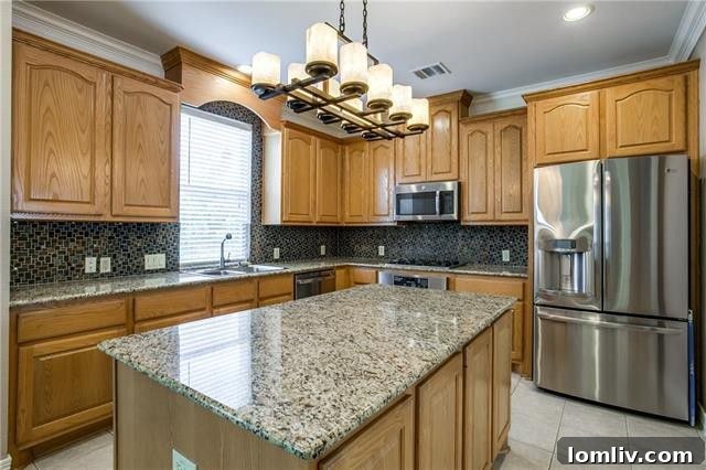 Luxurious master en-suite bathroom with dual sinks, jetted tub, and separate glass-enclosed shower.