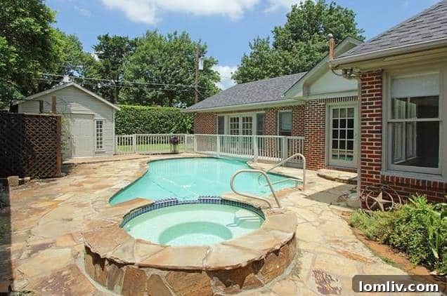 Inviting backyard with swimming pool, lawn, and privacy fence