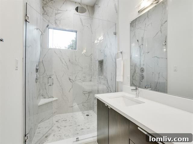 Your Turnkey Home Awaits in New Maple District for $555K 13 Elegant master bathroom with an oversized frameless glass shower and modern fixtures